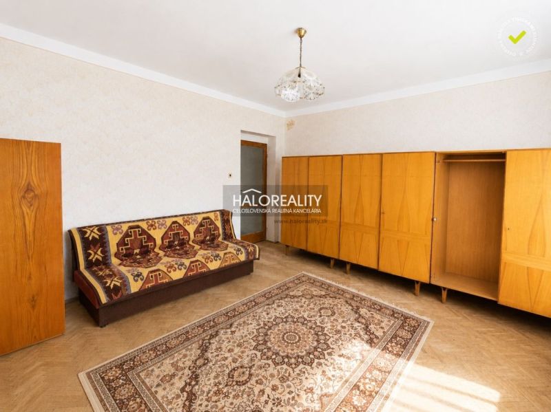 Living room with carpet and furniture, wooden decor flooring in a family house.
