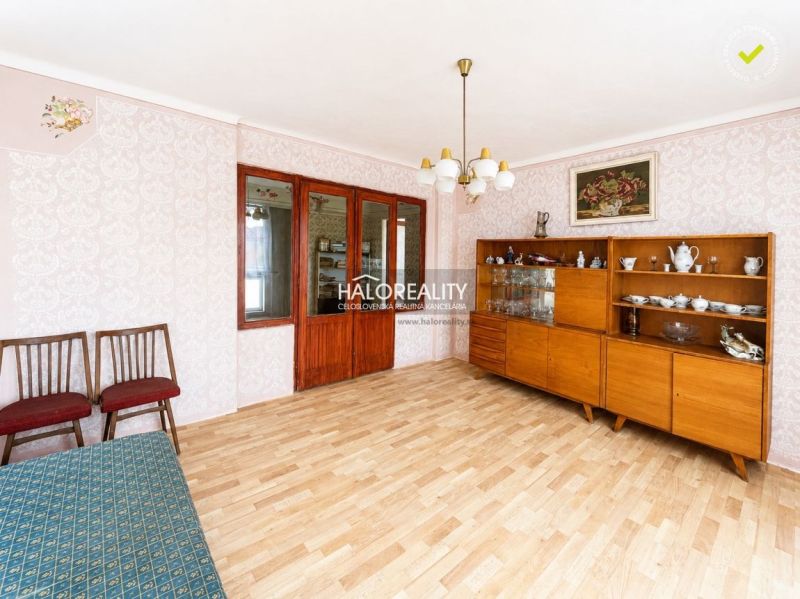 Living room in a family house with retro furniture and a wooden decor floor.