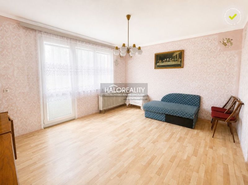 Living room with wood-decor flooring and furniture in a family house.
