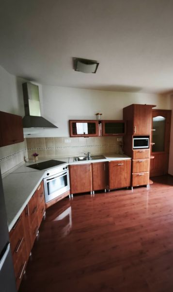 A kitchen with wooden decor, built-in appliances, and corner cabinets in a family house.
