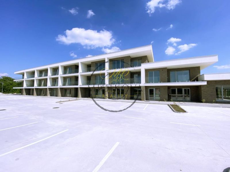 In Galanta, there is a three-story complex with parking space in front of the building.