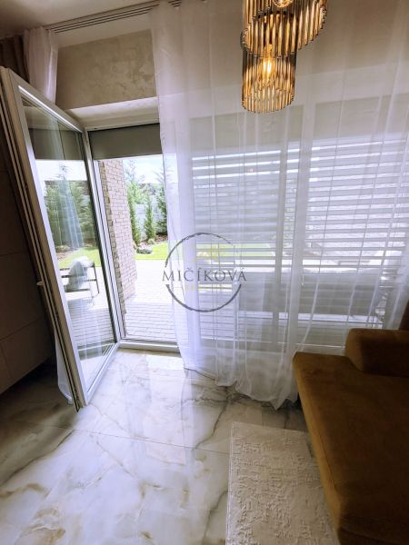 An open balcony in a 2-room apartment with marble-like tiles and stylish lighting.