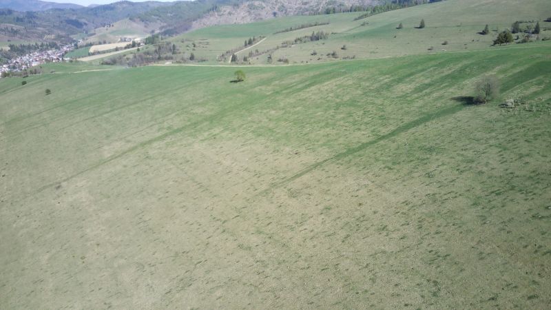 Extensive agricultural and forest lands in Čierny Balog with hills and pastures.