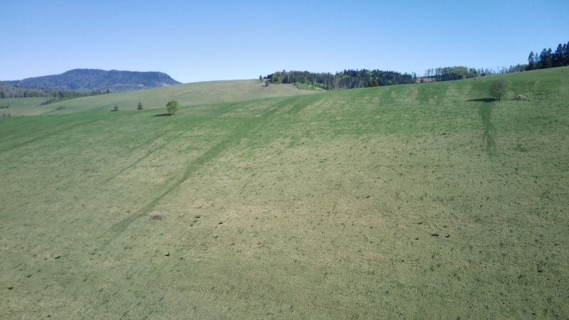 The landscape of Čierny Balog with extensive grass cover on agricultural and forest lands.
