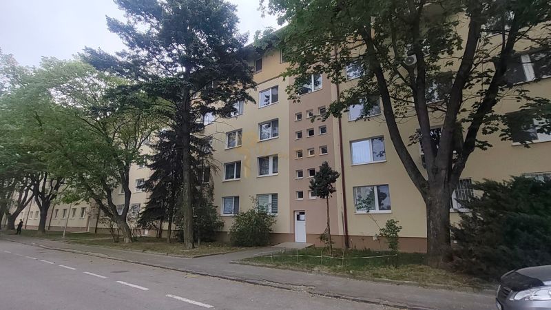 Apartment building on Exnárova Street in Bratislava - Ružinov surrounded by trees.