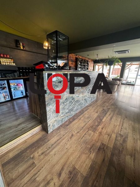 Commercial premises with a stylish interior, wood-patterned flooring, modern design.
