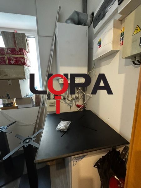 Interior of commercial premises with a workbench and tools in the room.