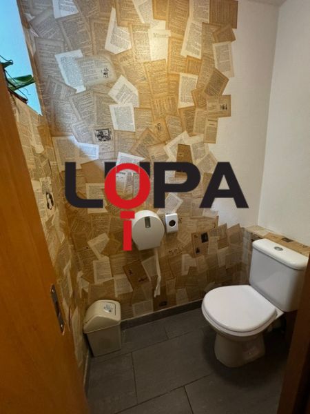 Interior of a restroom with creative paper wall decoration in commercial premises.