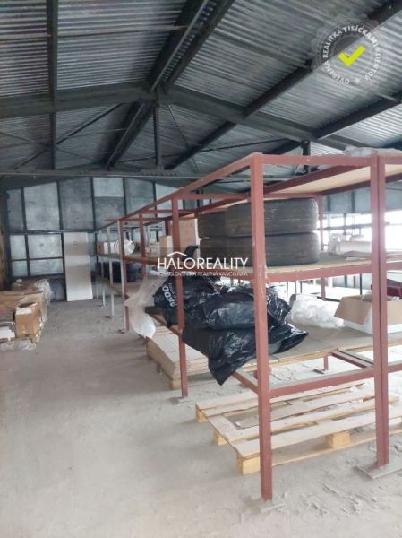 Warehouses and halls with metal shelves and stored items on the floor.