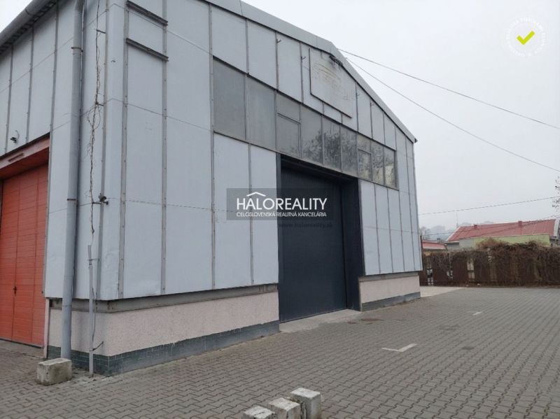 Warehouse in KE - Džungľa with a metal facade and paving in front of the entrance.