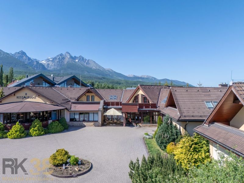 Hotel and guesthouse in Nová Lesná with a mountain backdrop.