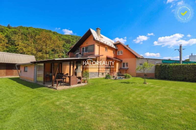 A family house in Dolná Mariková with a lawn and a gazebo in a natural setting.