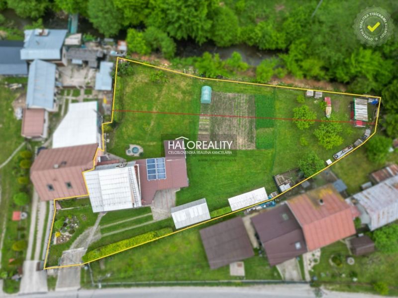 Aerial view of a family house in Dolná Mariková with a garden and solar panels.