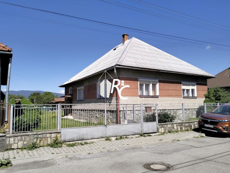 A family house on Štúrova Street in Sučany, with a large yard and a car in front.