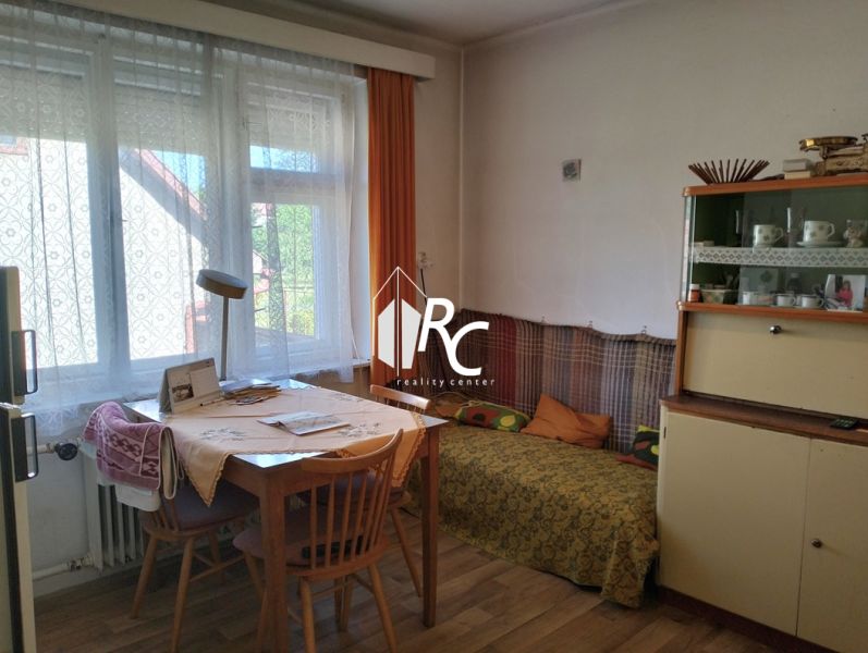 Interior of a family house with a dining table and a wooden decor floor.