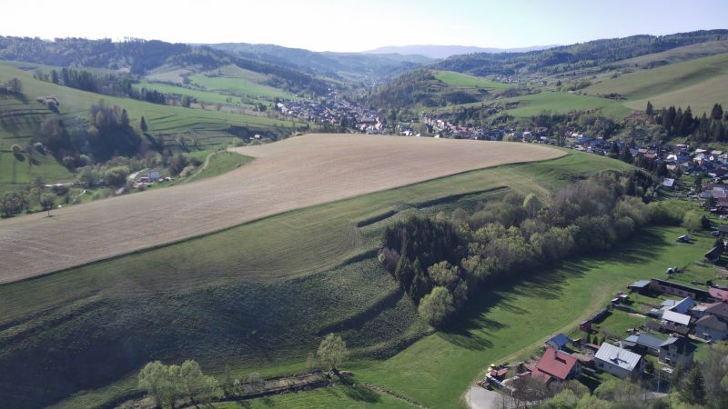 The landscape in Čierny Balog with agricultural and forest lands on the slopes of the hills.