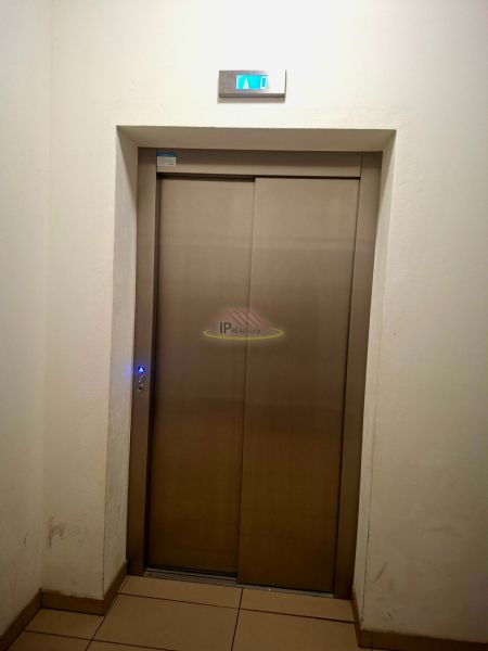 Metal elevator doors with a display in a studio apartment.