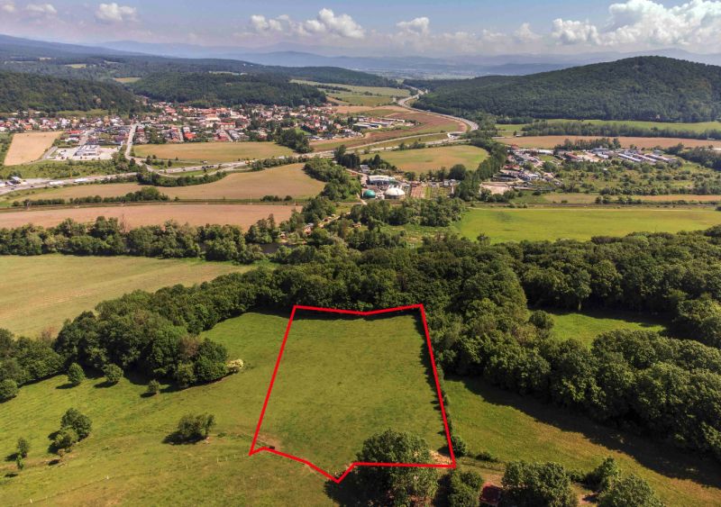 Recreational plots in Ostrá Lúka, surrounded by greenery and a village environment.