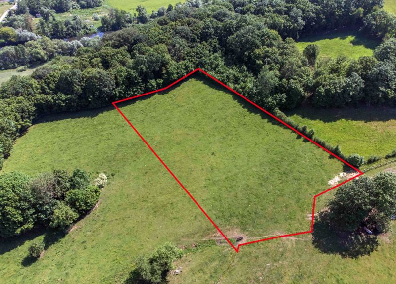 Aerial view of recreational plots in Ostrá Lúka with a forest in the background.