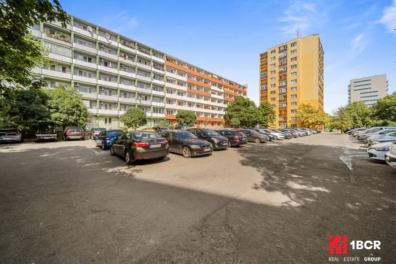 Parking lot with cars between apartment buildings on Československých Parašutistov Street in Bratislava - Nové Mesto.