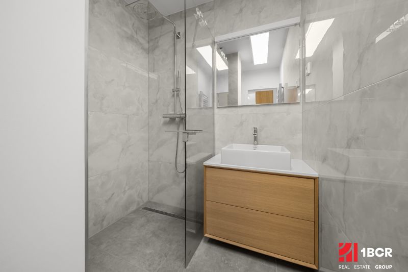 Bathroom with a shower and a sink in a 3-room apartment, ceramic tiles.