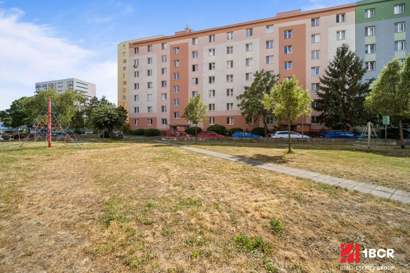 An apartment building surrounded by a playground on Československých Parašutistov Street, Bratislava - Nové Mesto.