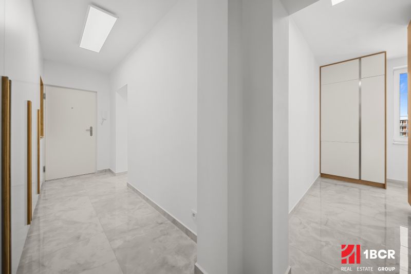 A hallway with white walls and a built-in wardrobe in a 3-room apartment.