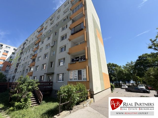 Apartment building on Dudvážska Street in Bratislava - Podunajské Biskupice with balconies and greenery.