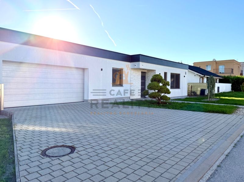 Family house on Lipová Street in Pata with a garage and a landscaped front garden.