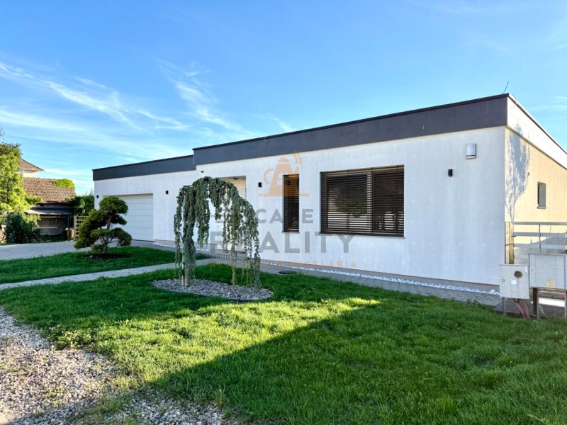 A family house on Lipová Street in Pata, with a well-maintained garden and a garage.