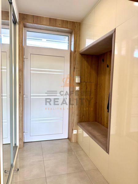 Entrance hall in a family house with a tiled floor and storage space with a wooden decor.