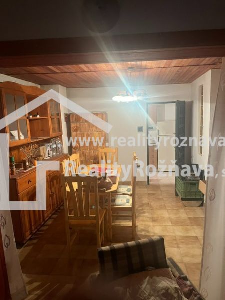 Dining area in a cabin with wooden furniture and lighting.