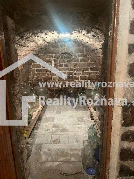 Stone cellar with an arched ceiling and shelves for storage, Cottage.