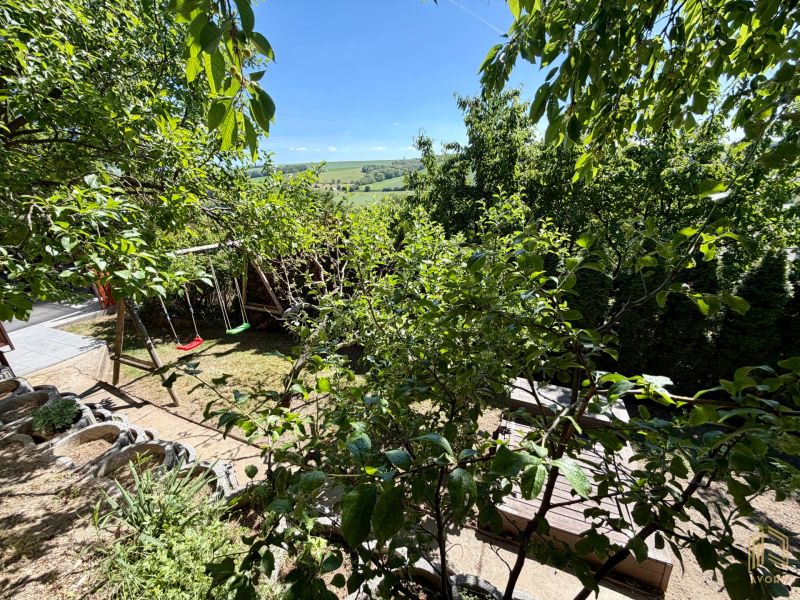 A garden by the cottage in Kunov, Senica, with swings and a view of the hills.