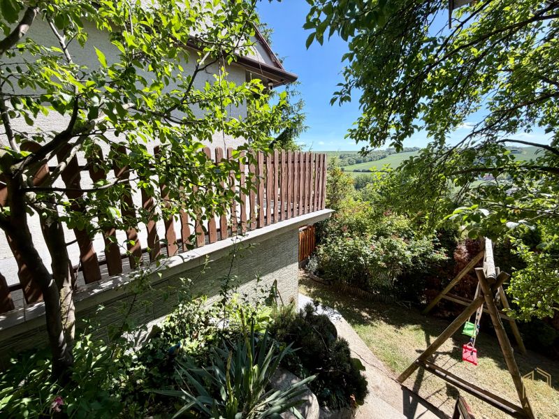 The garden of the cottage in Kunov in Senica with a swing and a view of the hills.