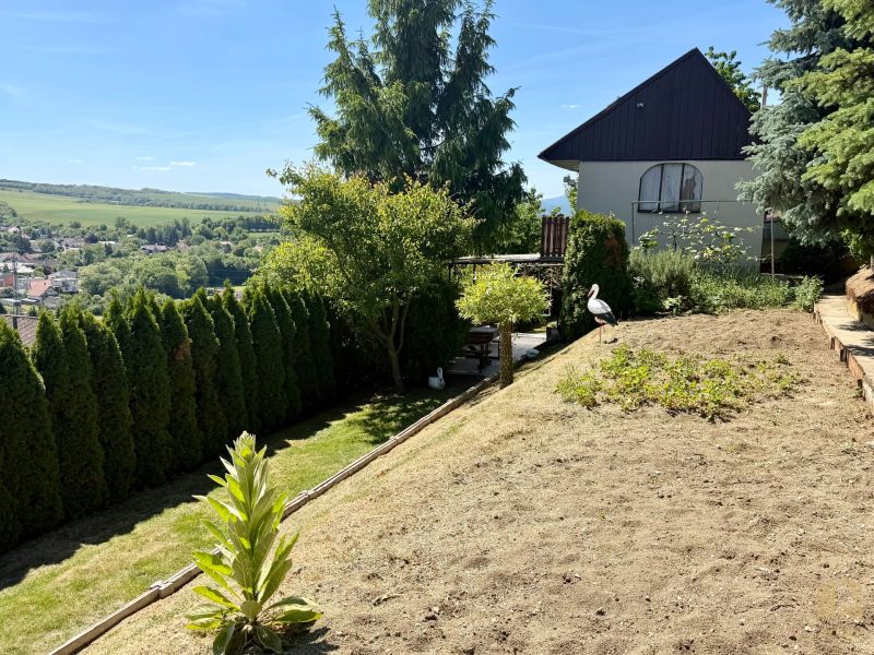 Garden by the cottage in Kunov, Senica with a view of the surrounding countryside and village.
