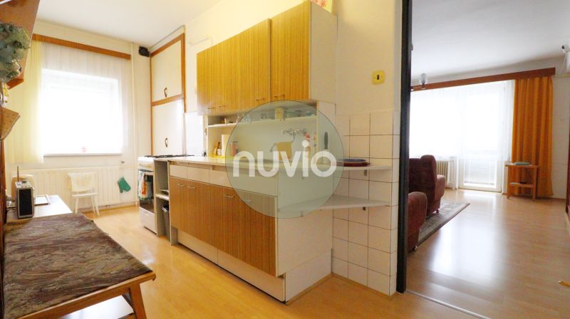 Kitchen and living room in a family house with a wooden decor floor.