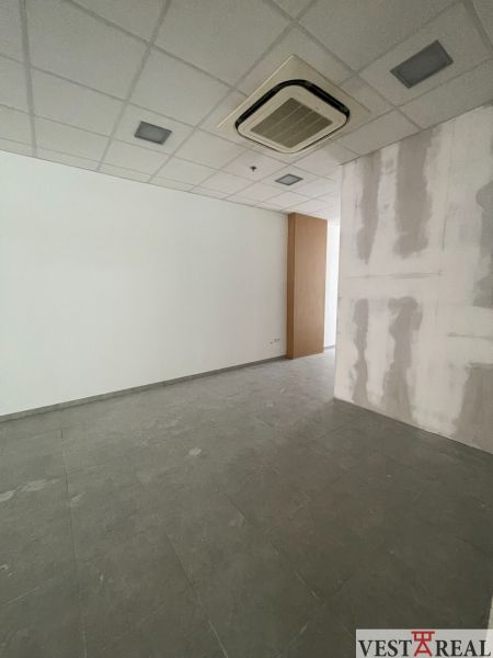 Offices with white walls and tile-patterned flooring.