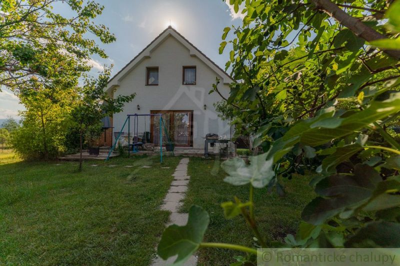 A family house in Bernolákovo with a large garden and a pathway amidst greenery.