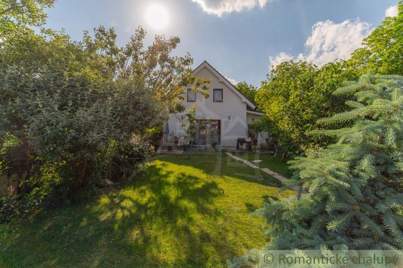 A family house in Bernolákovo surrounded by a lush garden on a sunny plot.