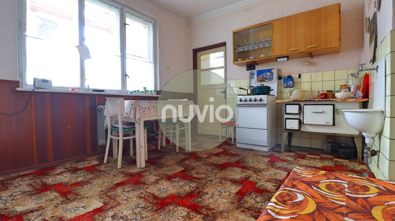 A kitchen in a family house with antique furnishings and a carpet, wooden decor.