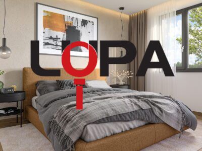 A modern bedroom in a family house with a comfortable box spring bed and decorative elements.