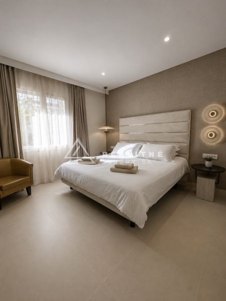 Bedroom in a 4-room apartment with a double bed, light flooring, and neutral curtains.