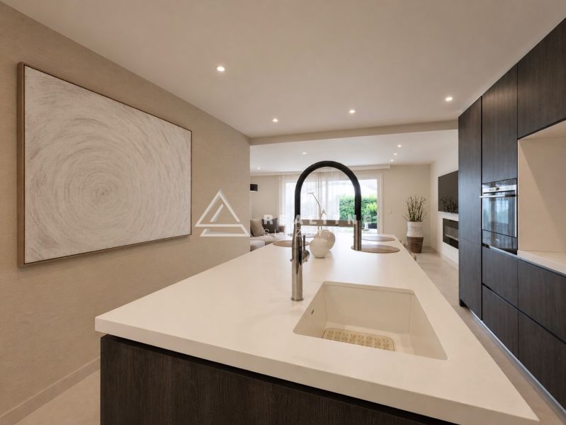 A kitchen in a 4-room apartment with an island and built-in appliances.