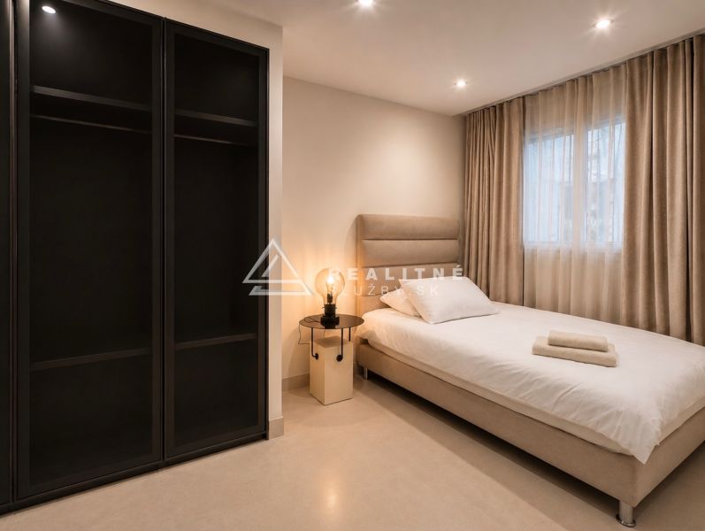 Bedroom in a 4-room apartment, simple bed, nightstand, and wardrobe.