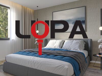 Bedroom in a family house with a large bed and a decorative wall.