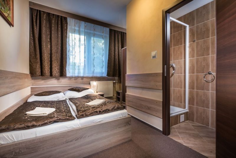 Comfortable room with a bed, carpet, bathroom in hotels and guesthouses.