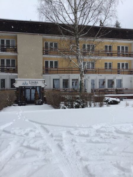 Hotel and guesthouse in Liptovský Ján with a snow-covered roof and exterior.