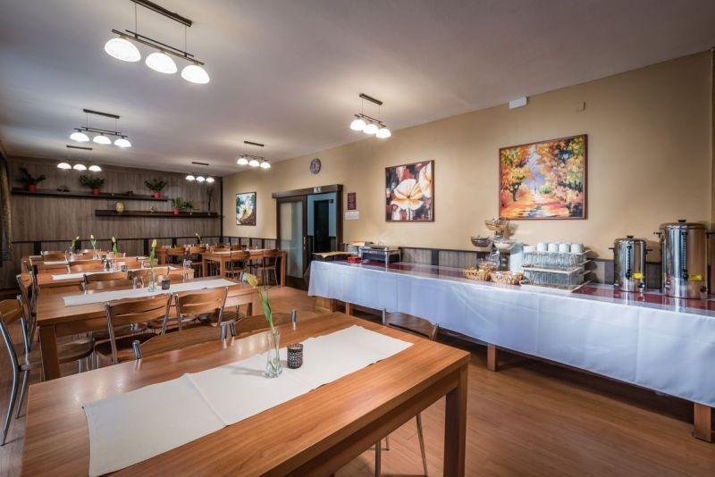 Dining room with a buffet table and wooden decor flooring in hotels and guesthouses.