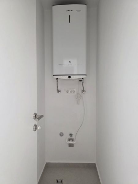 A boiler located in a white wall in a 4-room apartment.